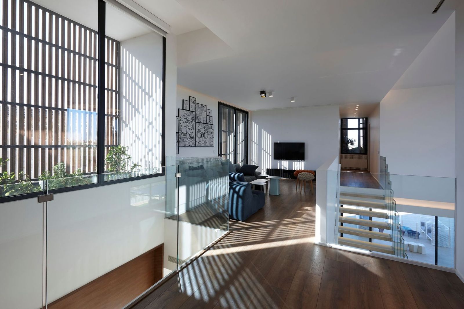 the light mural — striped shadow across the upper level